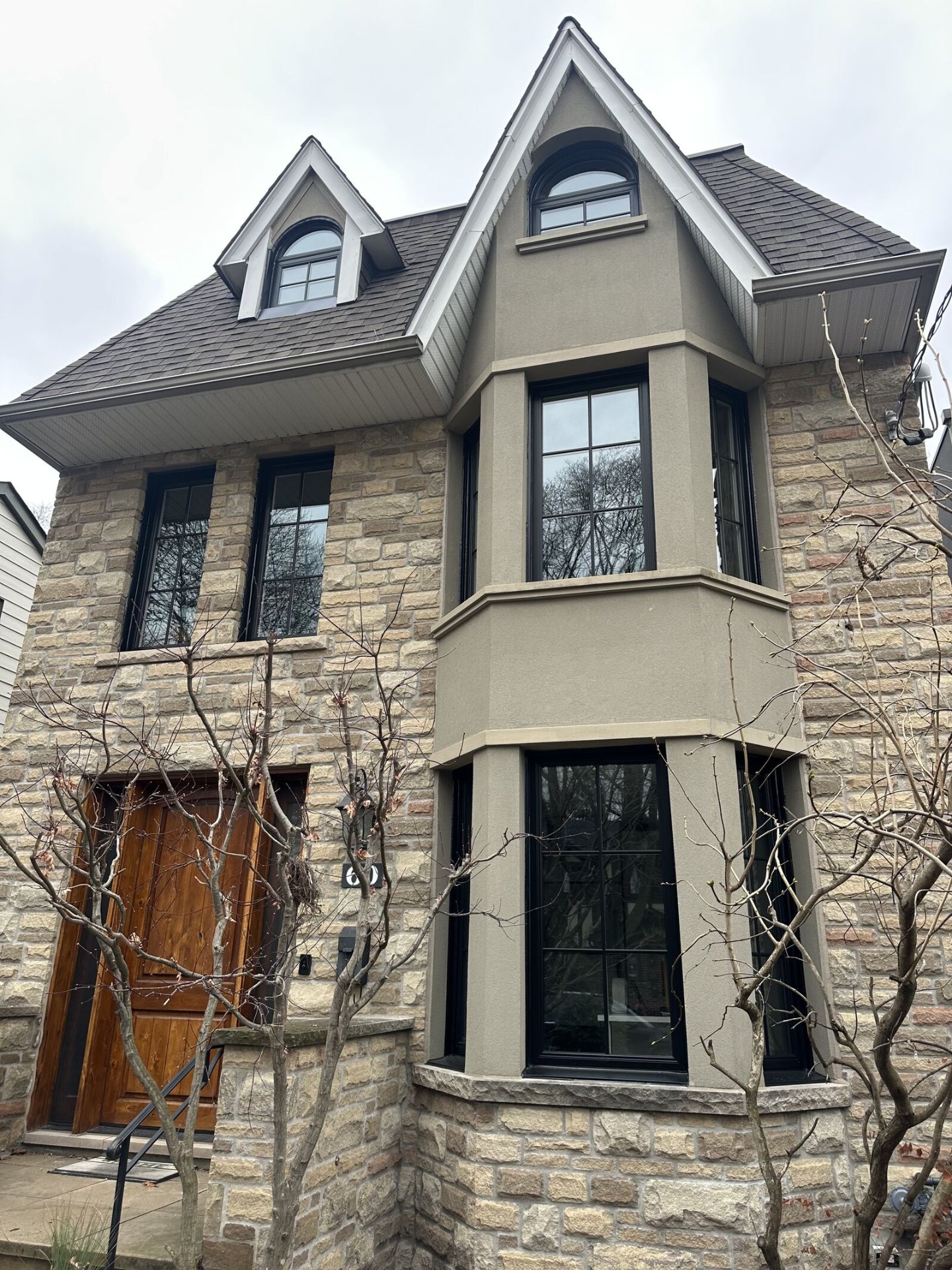 Same stone-fronted home with black-framed windows